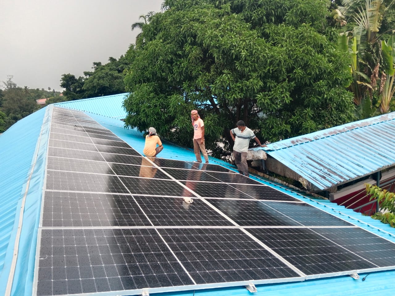 Ecosolis technicians servicing solar panels on a rooftop in Andaman